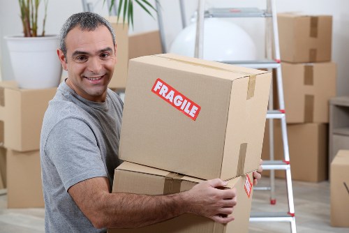 Staff using PPE while loading furniture into a van