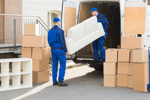 Removal team planning a home move in Woolwich with boxes and furniture