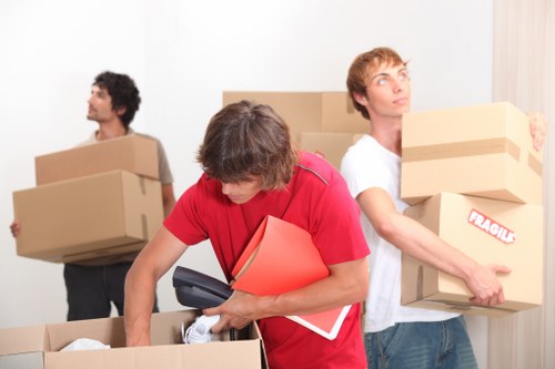 Removalists loading items carefully during a Woolwich home relocation